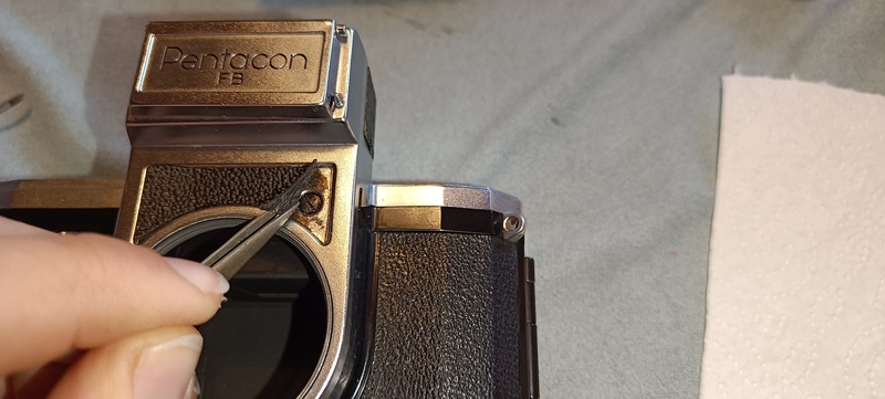 Screws for removing the front cover, hidden under a small piece of leather